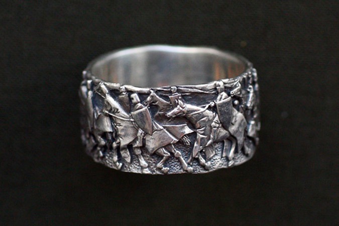 Silver ring with horse warriors.