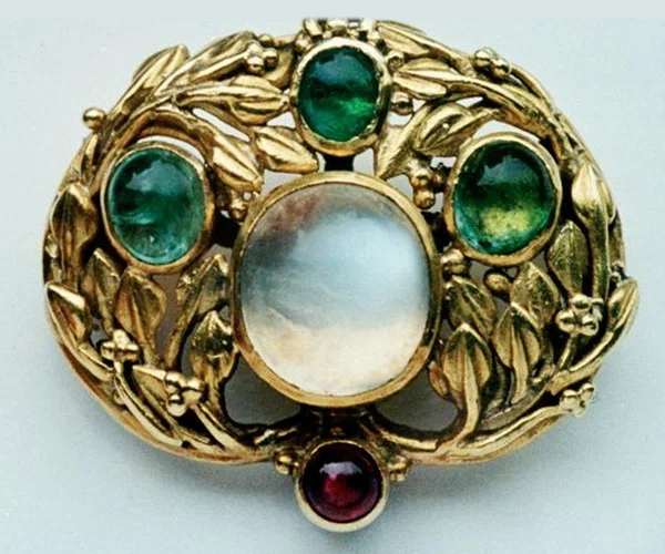 Gold brooch with moonstone, emeralds and ruby by John Paul Cooper, circa 1905