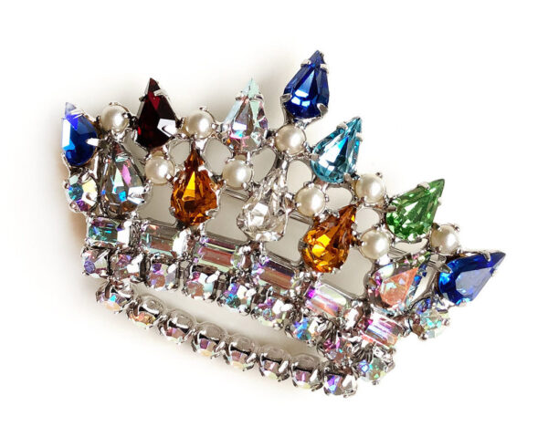 Brooch in the form of a crown with multi colored rhinestones.