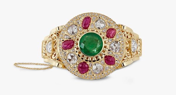 Beldi bracelet in yellow gold with emeralds rubies and rosettes. Beldi bracelet in yellow gold with emeralds rubies and rosettes.