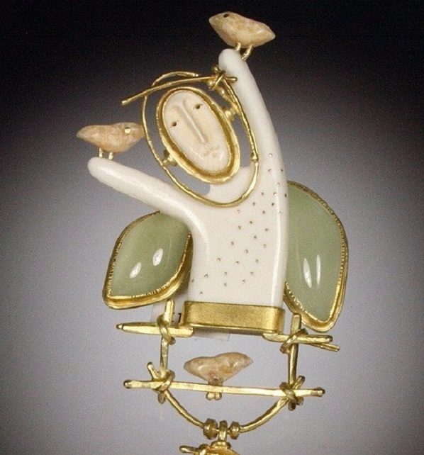 Brooch in the shape of a man with natural stones.