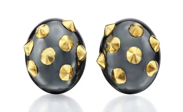 A pair of hematite and gold clips Each is made in the form of a hematite bombe plate embellished with polished gold appliques