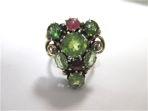 A Peridot And Ruby Ring Attributed To Dorrie Nossiter.