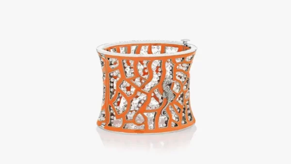 Crafted from 18k white gold and orange titanium, this stunning cuff bracelet from Lugano Diamonds features over 70 carats of diamonds. A seahorse encrusted with diamonds looks as if it is buried in a thicket of coral. This product is the most luxurious resort jewel.