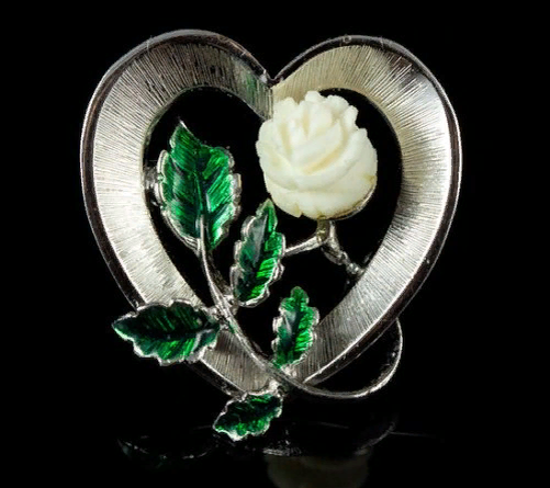 Gilt silver brooch with hand carved ivory rose and enamel leaves.