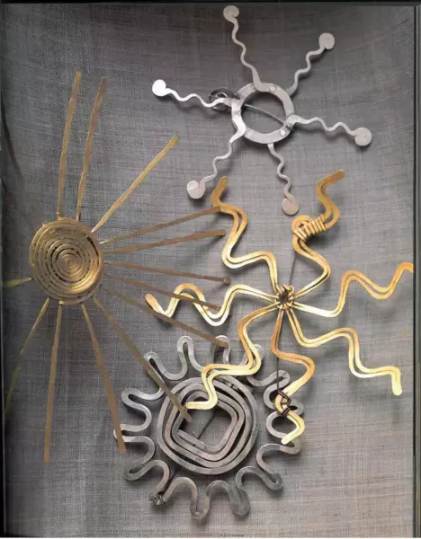 Sculpture brooches in the form of sun rays.