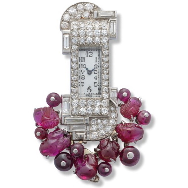 Watch brooch with carved rubies and diamonds set in platinum, Mauboussin, circa 1920.