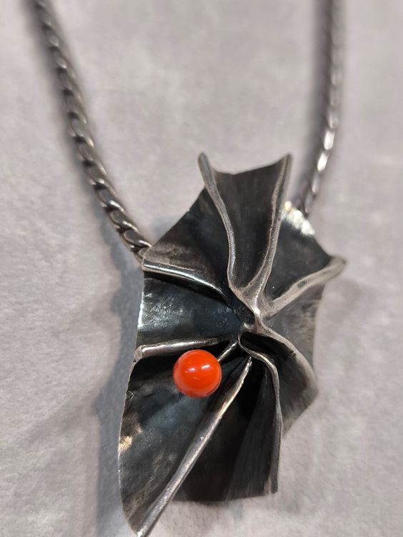 Silver pendant with coral.