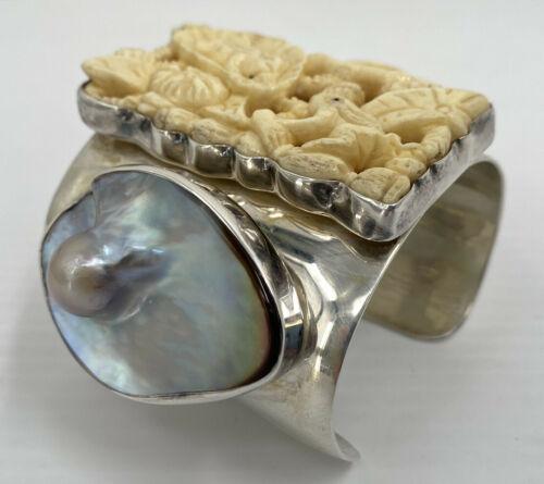 Silver wide bracelet with carved stone.