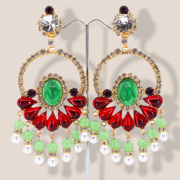 gold tone statement earrings feature a drop chandelier earring design on a three dimensional structure.