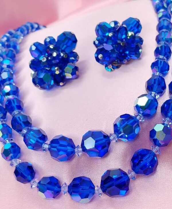A set of beads and earrings made of blue glass beads. A set of beads and earrings made of blue glass beads.