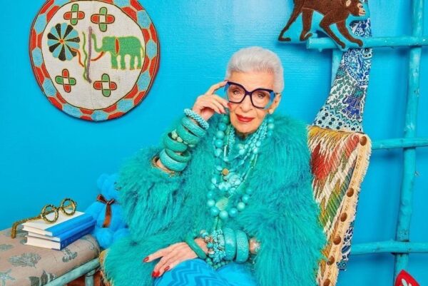 Aris in a turquoise outfit with many turquoise bracelets.