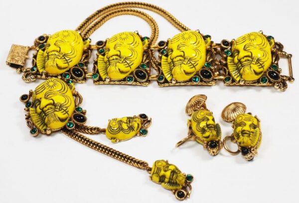 Bracelet, earrings and brooch with multi colored stones and yellow faces.