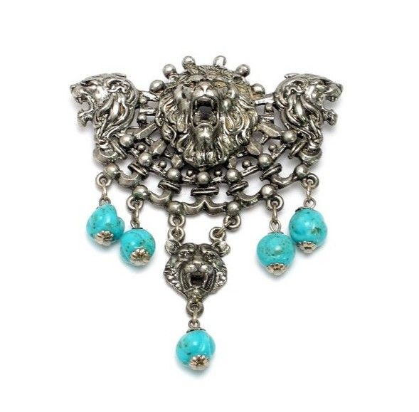 Brooch with lion heads and turquoise pendants.