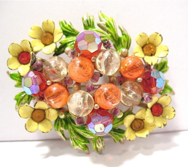 Colourful brooch in the form of a wreath of flowers with glass beads and enamel.