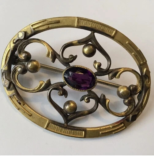 Copper brooch with amethyst.