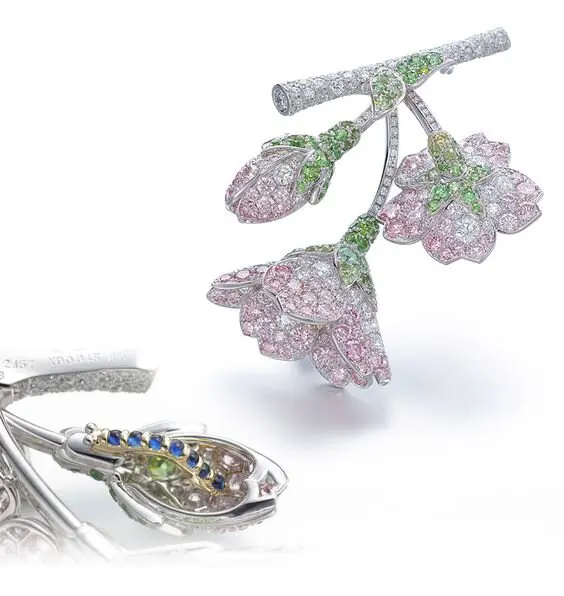 Floral brooches with pink sapphires.