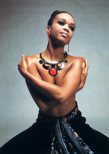 Model wearing LANGANI jewellery with a large coral stone.