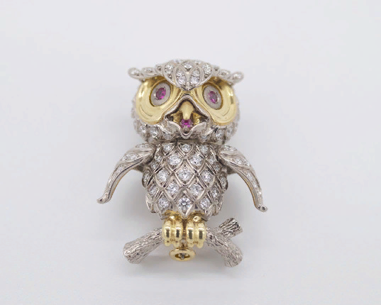 Owl brooch made of yellow and white gold with amethyst eyes.