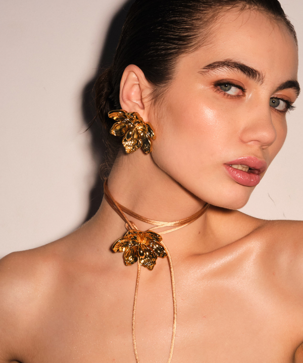 Set of gold plated flower earrings and necklace with flower.