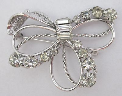 Silver brooch bow with rhinestones. Silver brooch bow with rhinestones.