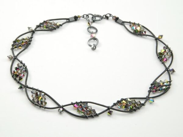 Spiral necklace made of wire and beads.