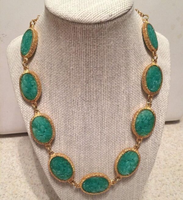 Gold tone necklace with green carved stones. Gold tone necklace with green carved stones.
